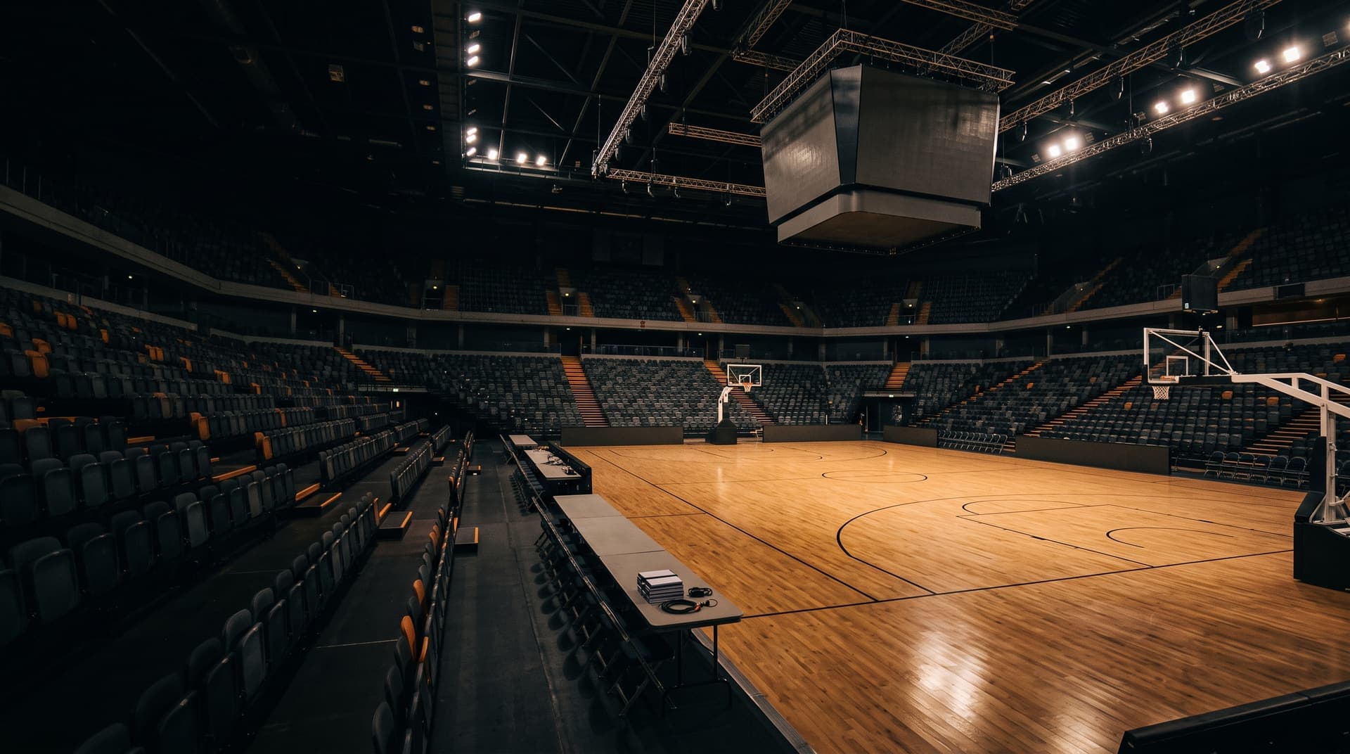 An empty British basketball arena lit for a fixture